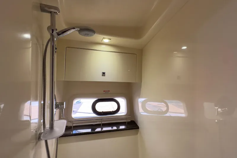 Baby Pie Yacht Photos Pics 2016 Sea Ray 470 Sundancer bathroom with shower, window, and storage cabinet.