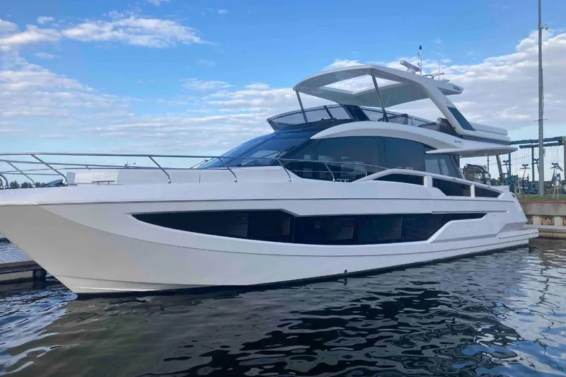  Yacht Photos Pics 2023 Galeon 640 Fly yacht docked, showcasing sleek design and modern architecture.