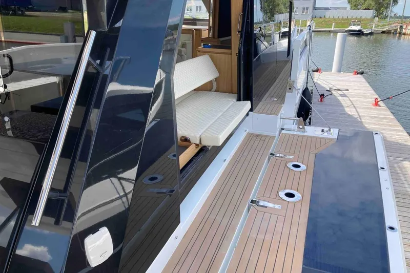  Yacht Photos Pics 2023 Galeon 640 Fly yacht docked, showcasing sleek deck design and luxurious seating.