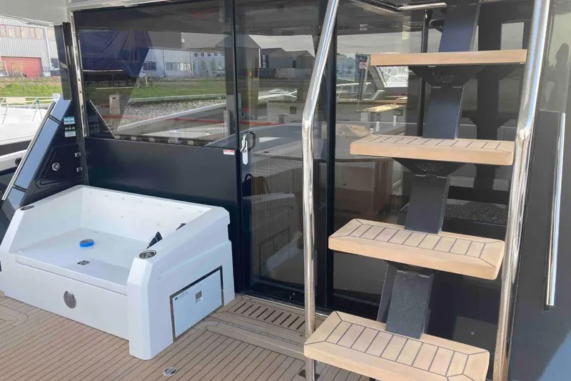  Yacht Photos Pics 2023 Galeon 640 Fly yacht with modern staircase and sleek deck design.