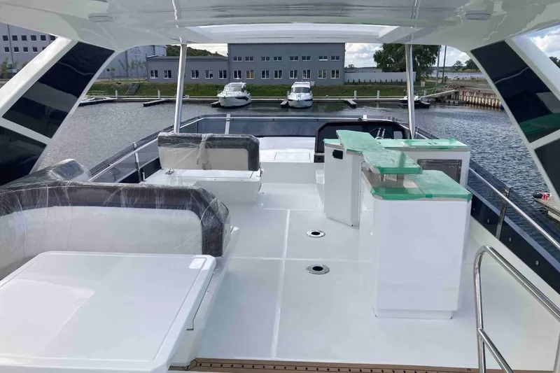  Yacht Photos Pics 2023 Galeon 640 Fly yacht deck with modern seating and bar area.