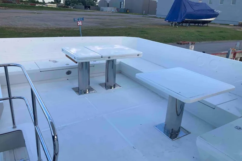  Yacht Photos Pics 2023 Galeon 640 Fly yacht deck with sleek white seating and tables.