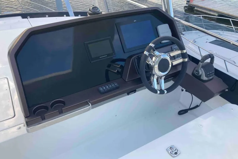  Yacht Photos Pics Helm of 2023 Galeon 640 Fly yacht with modern steering and navigation controls.