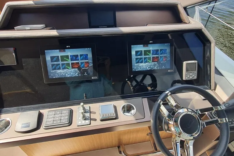  Yacht Photos Pics Control panel of 2023 Galeon 640 Fly yacht with modern navigation screens.