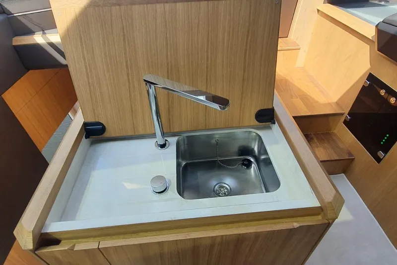  Yacht Photos Pics Modern kitchen sink on 2023 Galeon 640 Fly yacht with wooden cabinetry.