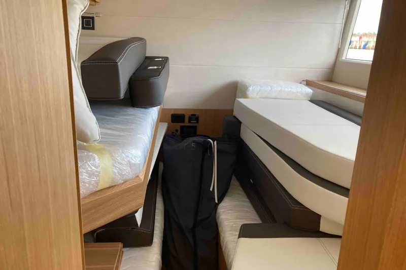  Yacht Photos Pics Interior cabin of 2023 Galeon 640 Fly yacht with stacked mattresses and cushions.