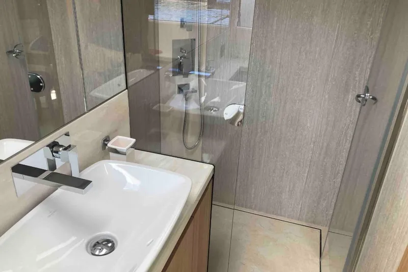  Yacht Photos Pics Modern bathroom interior on 2023 Galeon 640 Fly yacht, featuring sleek fixtures and glass shower.