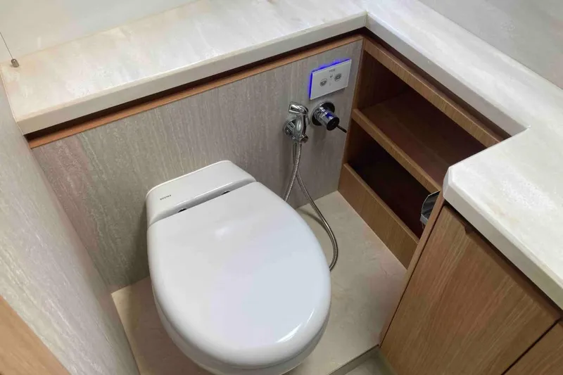  Yacht Photos Pics Luxury bathroom on 2023 Galeon 640 Fly yacht with modern toilet and wooden cabinetry.