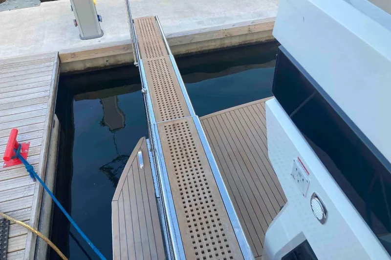  Yacht Photos Pics Galeon 640 Fly 2023 yacht docked with gangway and wooden deck.