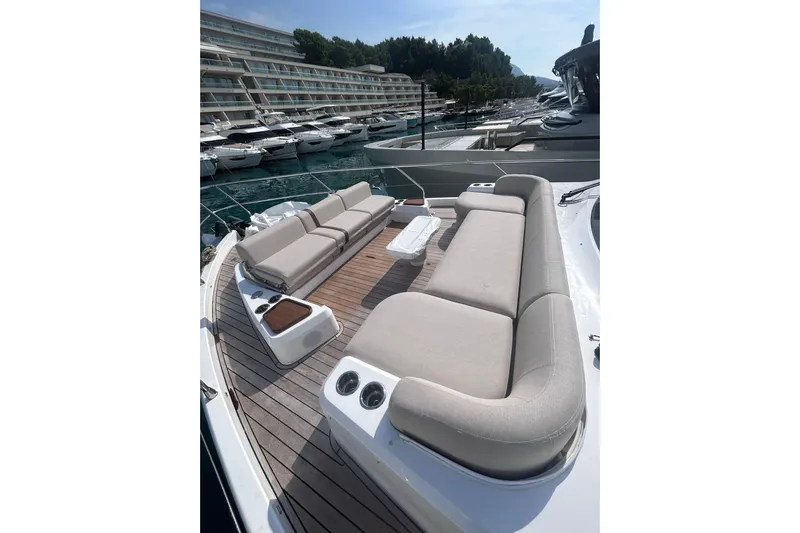  Yacht Photos Pics Luxurious 2025 Azimut Fly 62 yacht with spacious deck seating in a marina setting.
