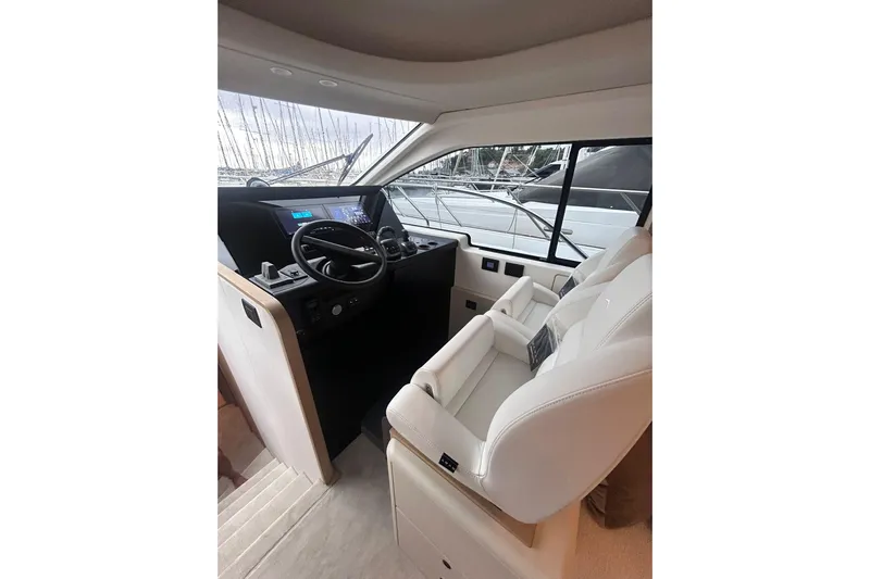  Yacht Photos Pics Luxurious interior of 2025 Azimut Fly 62 yacht with modern helm and plush seating.