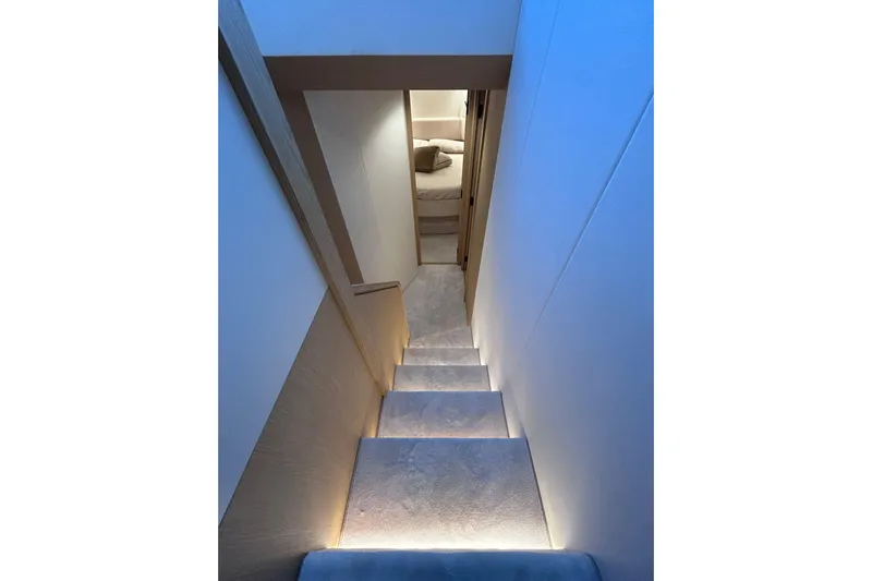  Yacht Photos Pics Staircase leading to a cozy bedroom in 2025 Azimut Fly 62 yacht.