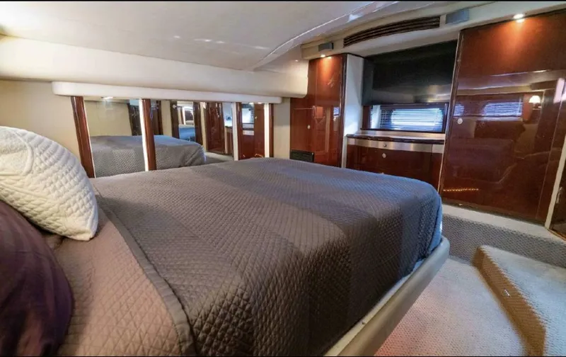  Yacht Photos Pics Luxurious bedroom interior of 2008 Sea Ray 58 Sedan Bridge yacht with elegant wood finishes.