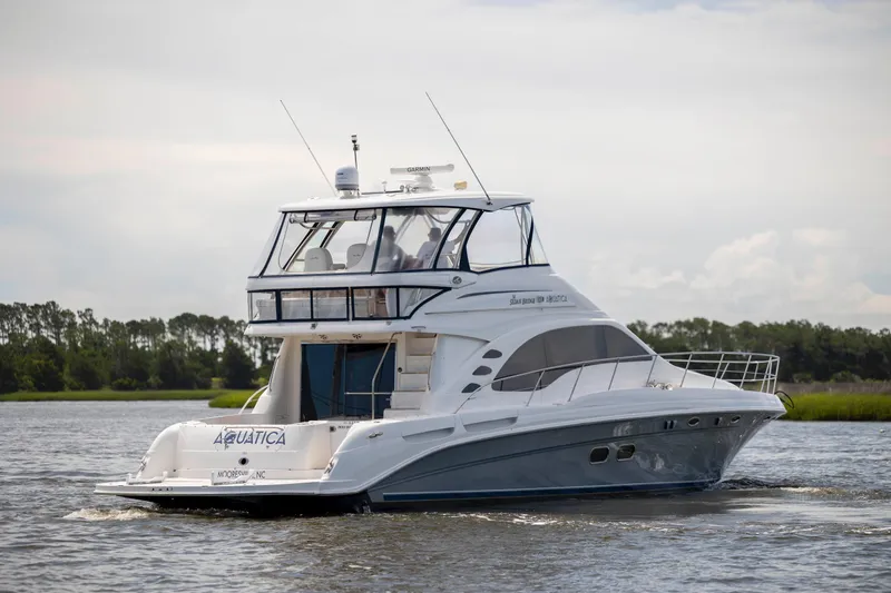  Yacht Photos Pics 2008 Sea Ray 58 Sedan Bridge yacht cruising on a calm river.