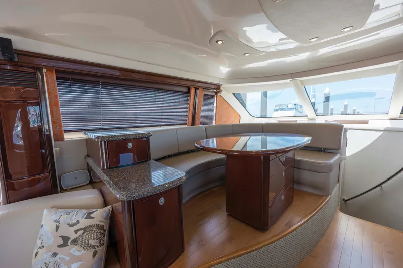  Yacht Photos Pics Luxurious interior of a 2008 Sea Ray 58 Sedan Bridge yacht with elegant seating and table.