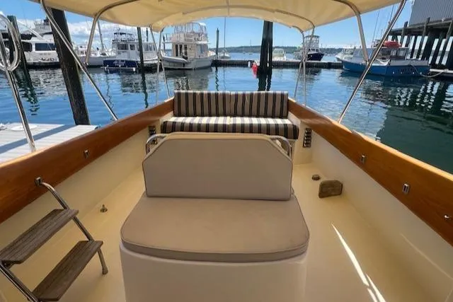 Free Will Yacht Photos Pics 2003 Hinckley Extended Hardtop Pilothouse 36 Picnic Boat interior with striped seating at marina.