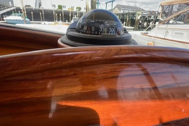 Free Will Yacht Photos Pics Compass on 2003 Hinckley Extended Hardtop Pilothouse 36 Picnic Boat, with polished wooden dashboard.