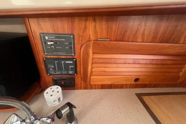 Free Will Yacht Photos Pics 2003 Hinckley Pilothouse 36 interior with control panel and wooden cabinetry.