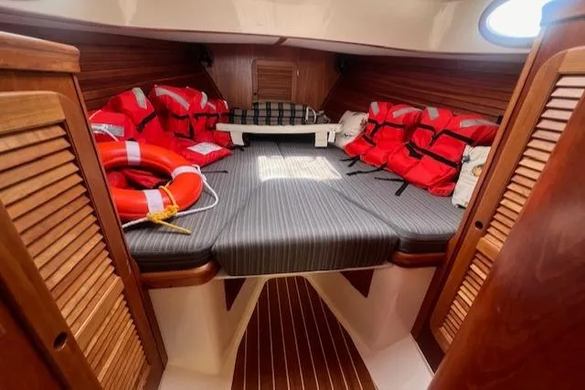 Free Will Yacht Photos Pics 2003 Hinckley Pilothouse 36 cabin with life jackets and striped bedding.