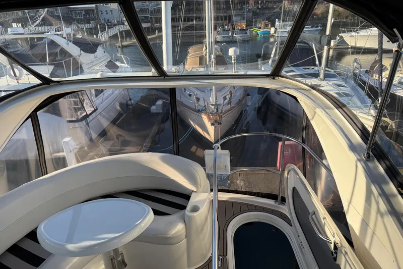  Yacht Photos Pics 2007 Meridian 341 Sedan yacht interior with marina view, featuring seating and table.