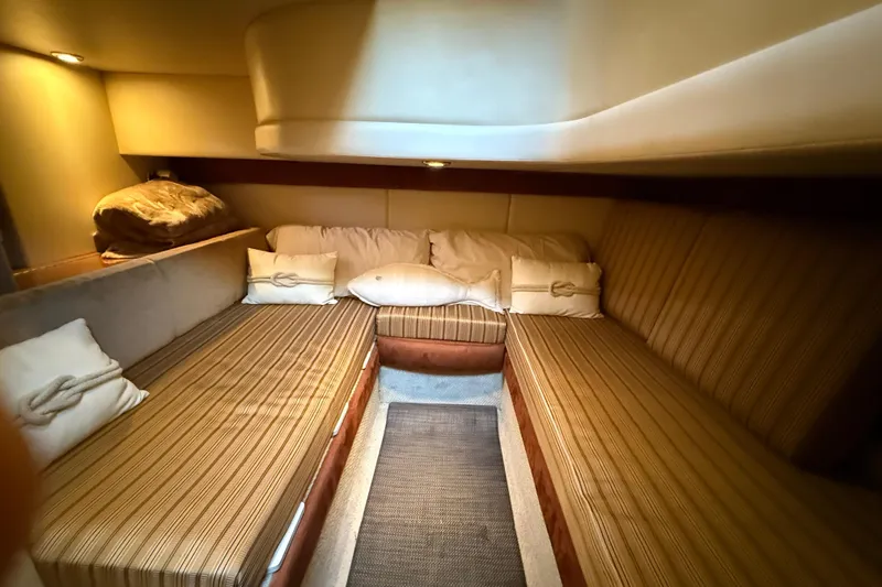  Yacht Photos Pics Cozy cabin interior of 2007 Meridian 341 Sedan with striped seating and soft lighting.