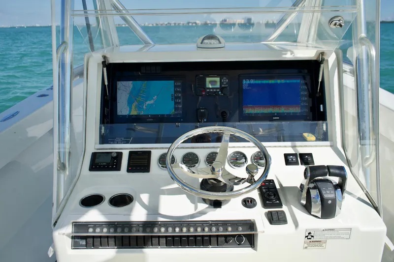  Yacht Photos Pics 2017 SeaVee 390Z boat dashboard with navigation screens and steering wheel.
