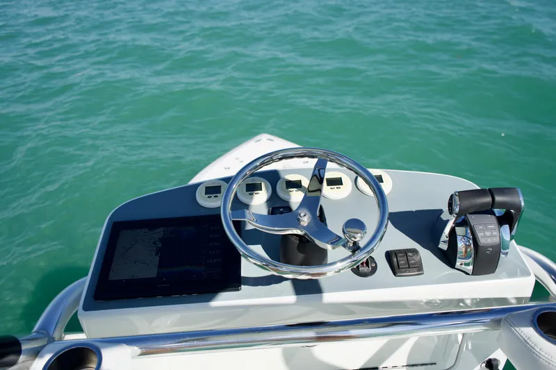  Yacht Photos Pics 2017 SeaVee 390Z boat helm with steering wheel and controls on turquoise water.