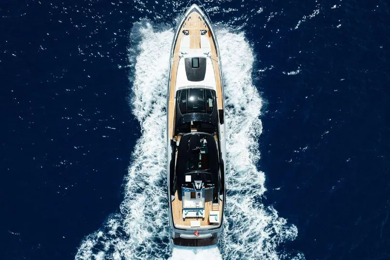 Clarity Yacht Photos Pics Aerial view of 2022 Riva 90' Argo yacht cruising on deep blue ocean waters.