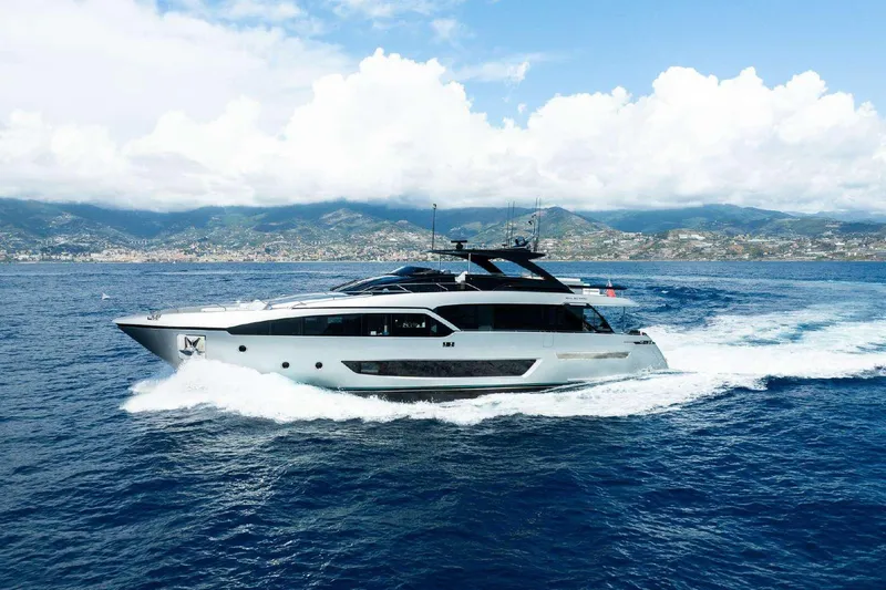 Clarity Yacht Photos Pics Luxury 2022 Riva 90' Argo yacht cruising on open sea with scenic coastal backdrop.