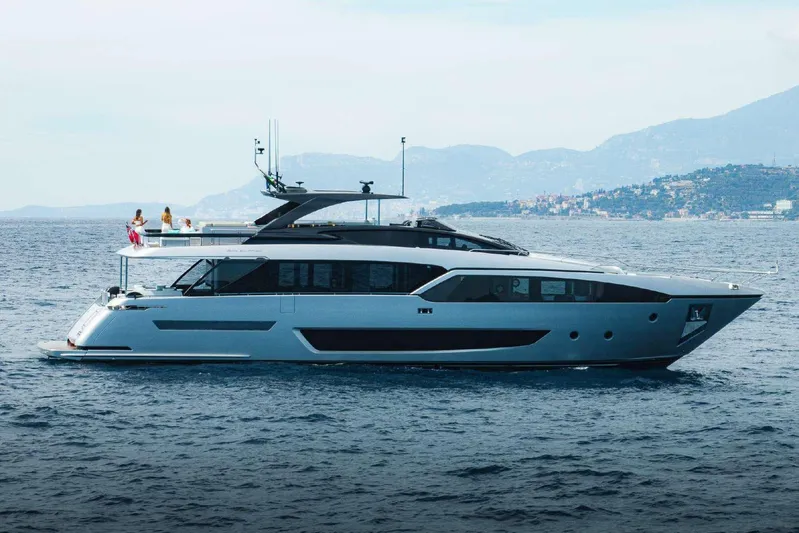 Clarity Yacht Photos Pics 2022 Riva 90' Argo yacht cruising on the sea with scenic mountain backdrop.