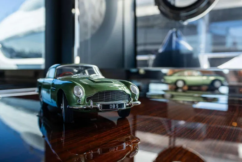 Clarity Yacht Photos Pics Model car on polished surface, reflecting luxury and elegance, aboard 2022 Riva 90' Argo yacht.