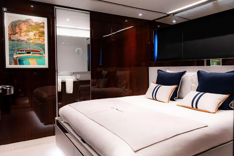 Clarity Yacht Photos Pics Luxurious bedroom interior on 2022 Riva 90' Argo yacht with elegant decor and modern amenities.