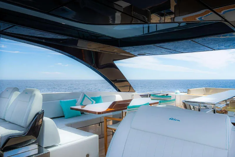 Clarity Yacht Photos Pics Luxurious 2022 Riva 90' Argo yacht interior with ocean view, featuring elegant seating and dining area.