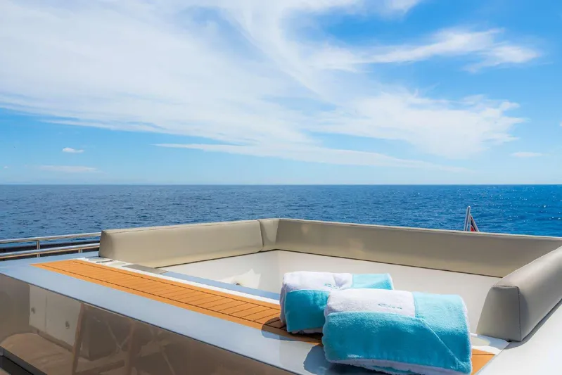 Clarity Yacht Photos Pics Luxurious 2022 Riva 90' Argo yacht deck with ocean view and plush towels.