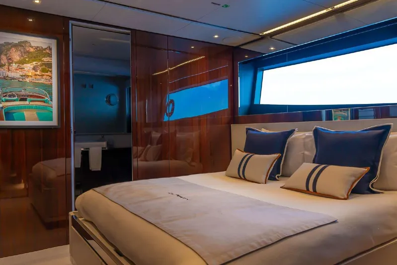 Clarity Yacht Photos Pics Luxurious bedroom interior of 2022 Riva 90' Argo yacht with elegant decor and large window.