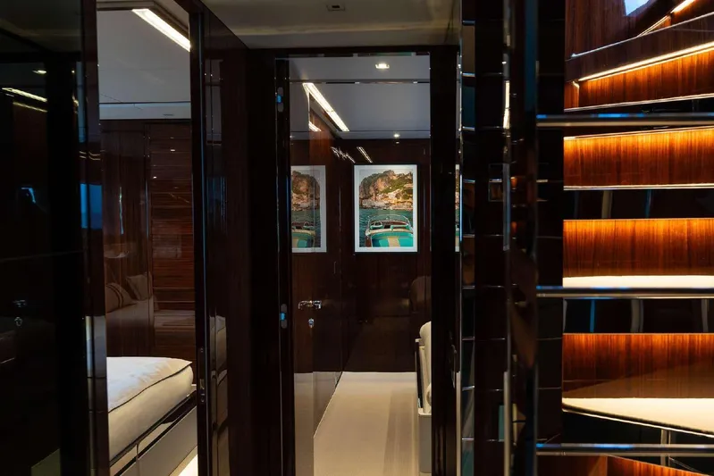 Clarity Yacht Photos Pics Luxurious interior of 2022 Riva 90' Argo yacht with elegant wood finishes and modern lighting.