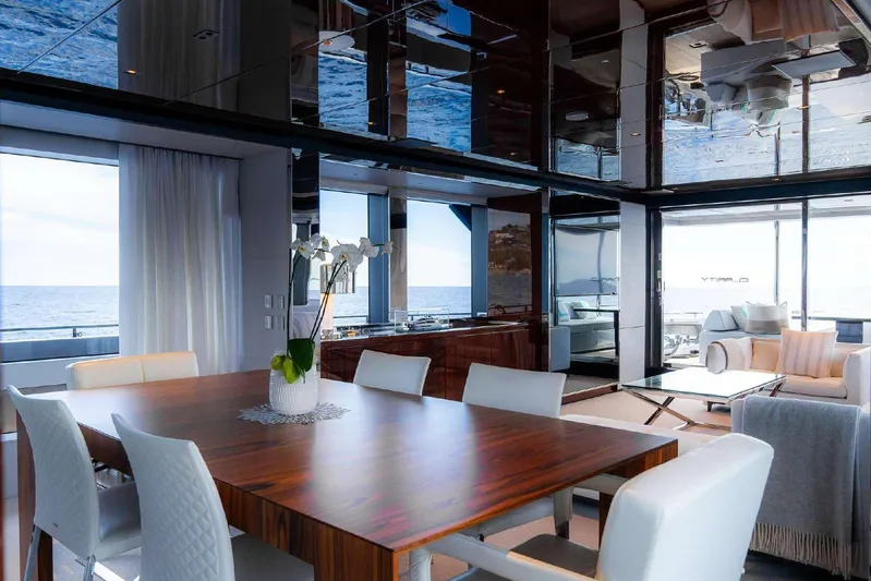 Clarity Yacht Photos Pics Luxurious interior of 2022 Riva 90' Argo yacht with elegant dining area and ocean view.