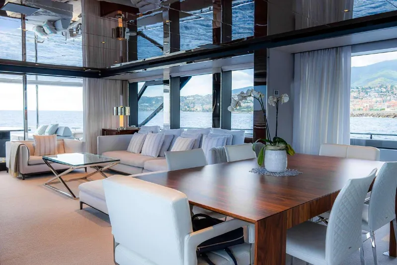 Clarity Yacht Photos Pics Luxurious interior of 2022 Riva 90' Argo yacht with elegant dining and seating area.