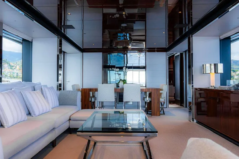 Clarity Yacht Photos Pics Luxurious interior of 2022 Riva 90' Argo yacht with elegant seating and dining area.