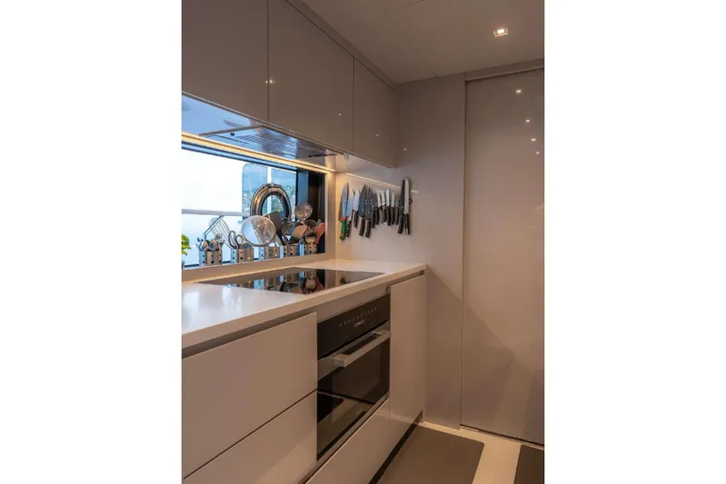 Clarity Yacht Photos Pics Modern kitchen interior on 2022 Riva 90' Argo yacht, featuring sleek design and appliances.