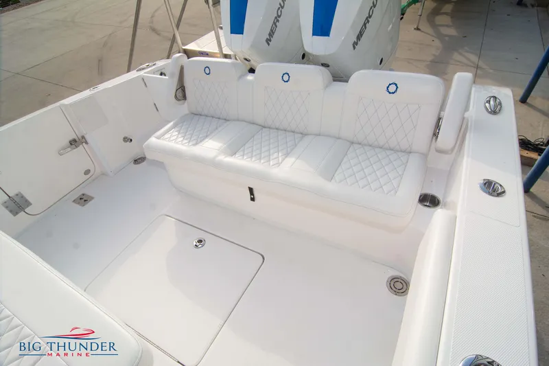  Yacht Photos Pics 2023 Fountain 34 CC boat interior with white cushioned seating and sleek design.