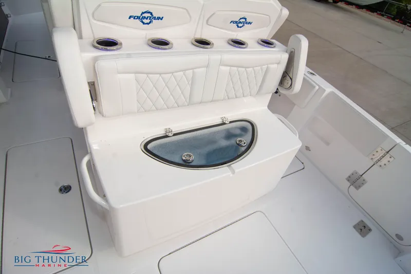  Yacht Photos Pics 2023 Fountain 34 CC boat seating with cup holders and storage compartment.