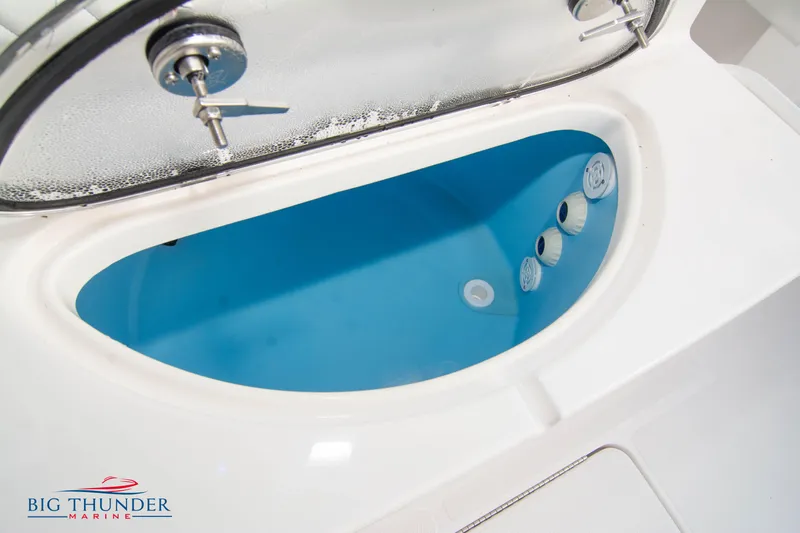  Yacht Photos Pics 2023 Fountain 34 CC boat livewell with blue interior and secure latch.