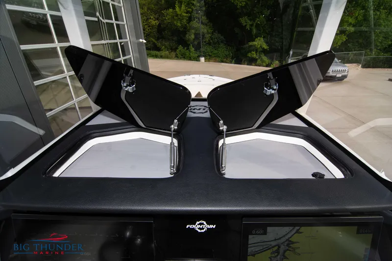  Yacht Photos Pics 2023 Fountain 34 CC boat dashboard with open hatches, showcasing sleek design and functionality.
