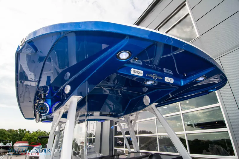  Yacht Photos Pics 2023 Fountain 34 CC boat with sleek blue canopy and modern design.