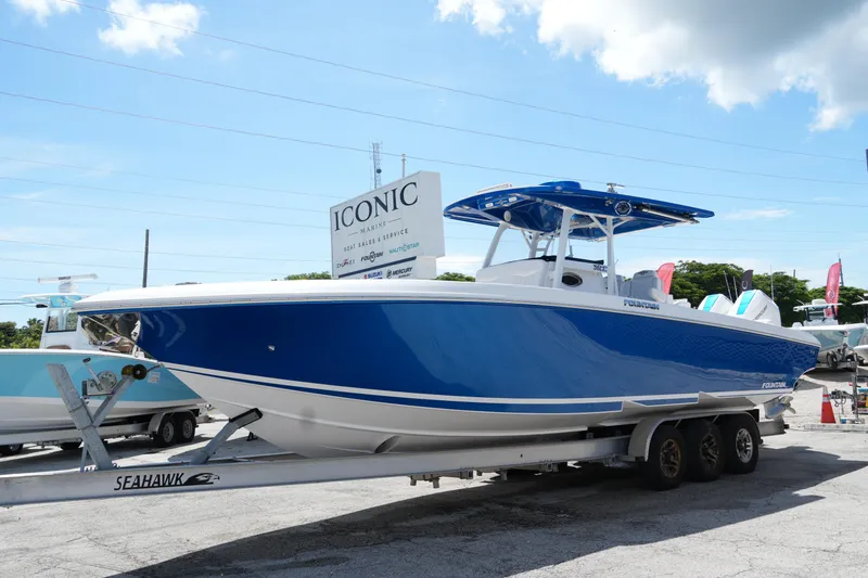  Yacht Photos Pics 2023 Fountain 34 Center Console boat on trailer at Iconic Marine dealership.