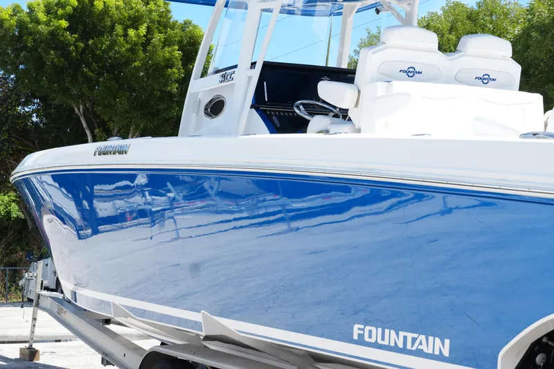  Yacht Photos Pics 2023 Fountain 34 Center Console boat with sleek blue hull and white seating.