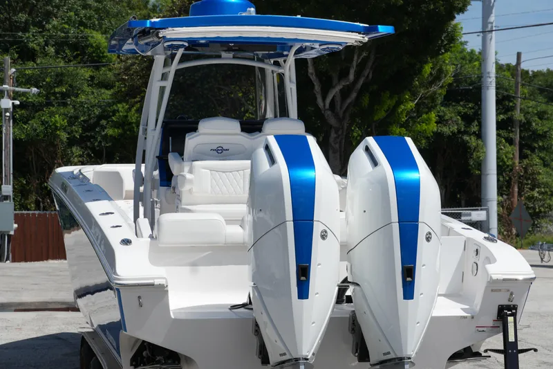  Yacht Photos Pics 2023 Fountain 34 Center Console boat with dual engines, sleek design, and blue accents.