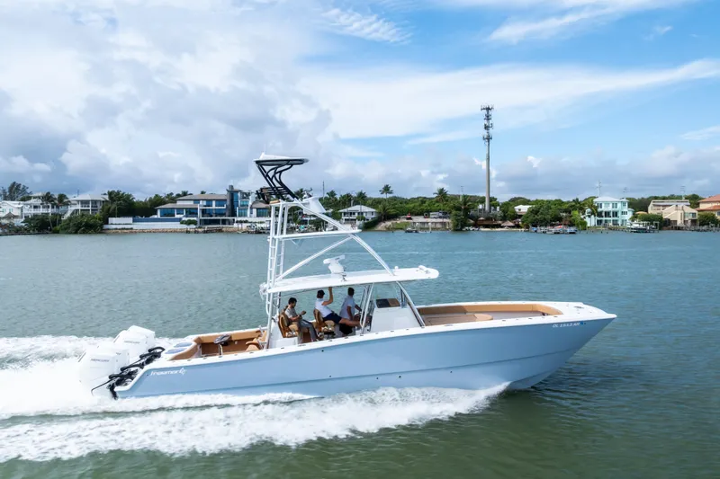  Yacht Photos Pics 2025 Freeman LR boat cruising on a scenic waterway with passengers onboard.