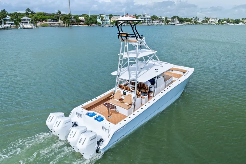  Yacht Photos Pics 2025 Freeman LR boat with triple engines cruising on a calm waterway.